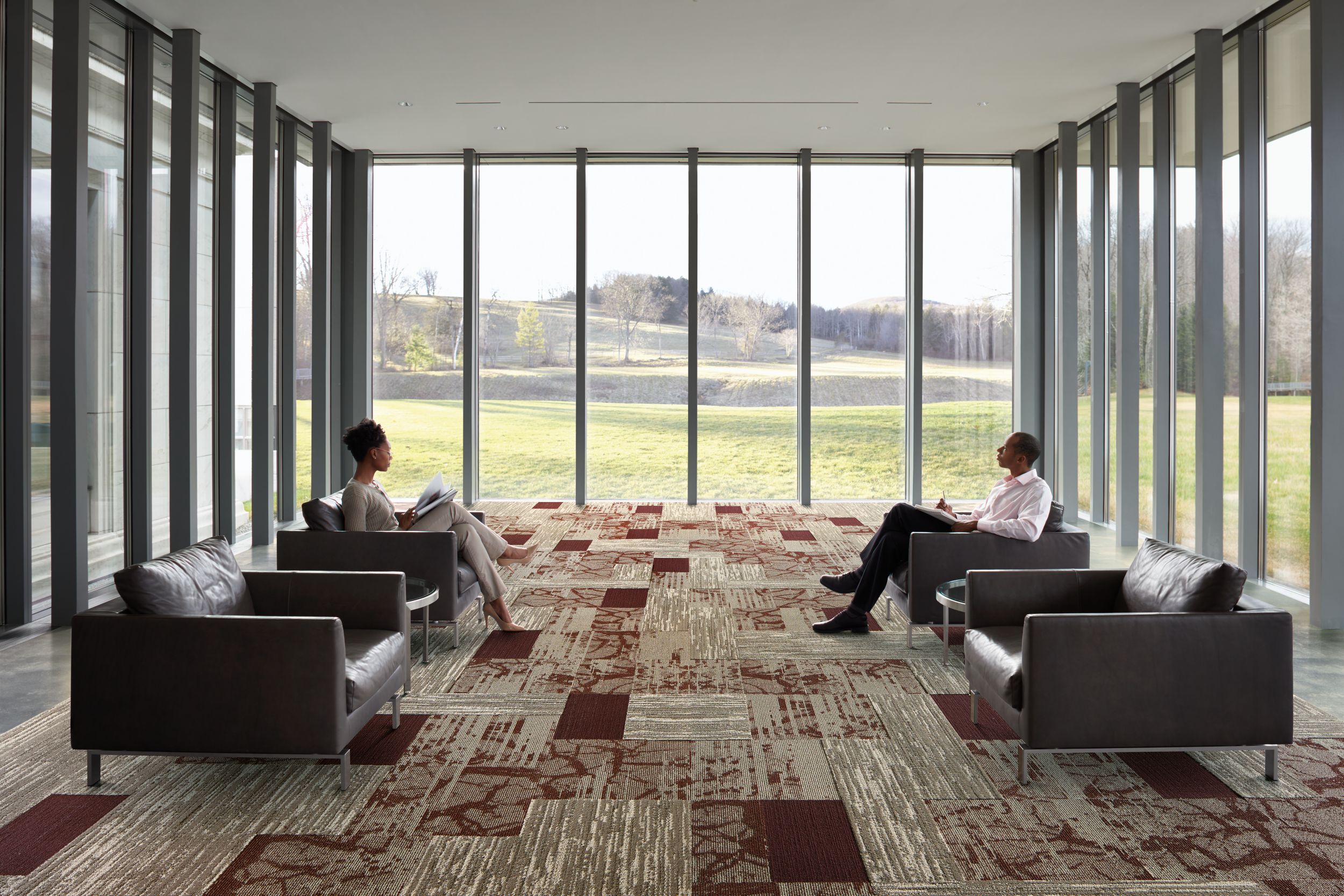 Interface Ground and Progression I carpet tile and Natural Stones LVT in multi-purpose room with walls of windows on three sides image number 13